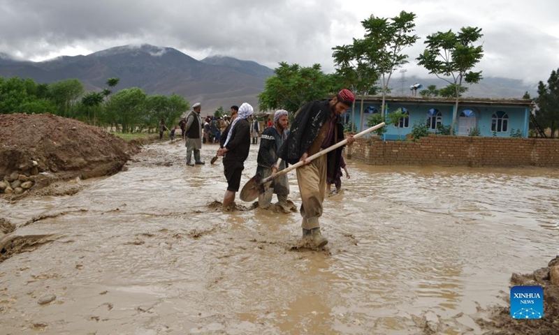 People work outside of damaged houses after a heavy rain in Baghlan province, Afghanistan, May 4, 2022. Eight people have been confirmed dead and 13 others injured as floods swept parts of the northern Baghlan and western Badghis provinces on Wednesday, officials said Thursday.(Photo: Xinhua)