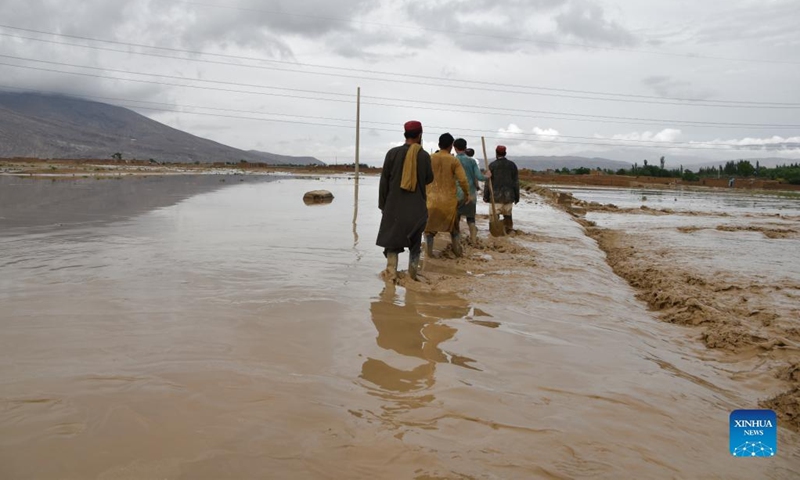People work outside of damaged houses after a heavy rain in Baghlan province, Afghanistan, May 4, 2022. Eight people have been confirmed dead and 13 others injured as floods swept parts of the northern Baghlan and western Badghis provinces on Wednesday, officials said Thursday.(Photo: Xinhua)