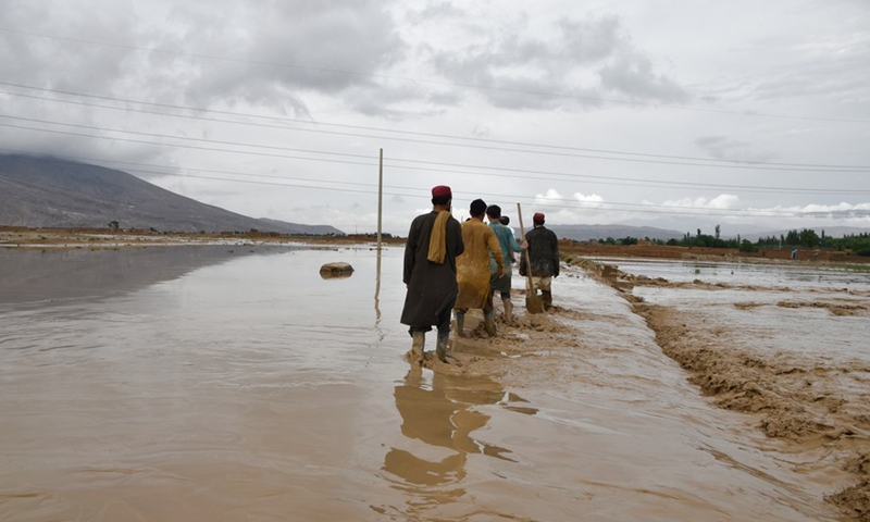 People work outside of damaged houses after a heavy rain in Baghlan province, Afghanistan, May 4, 2022.Photo:Xinhua