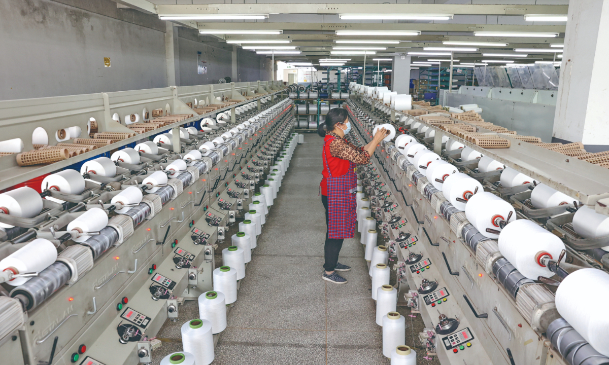 An employee works on a production line at a company manufacturing elastic fabric goods based in Nantong, East China’s Jiangsu Province on April 18, 2022. The company exports products to countries including Vietnam. Photo: cnsphoto