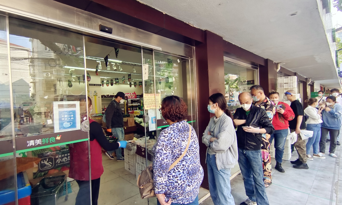 Shanghai residents queue up for shopping on May 6, 2022 at a fresh meat market, one of the businesses that have resumed operation as the city has made marked progress in containing Omicron variant.