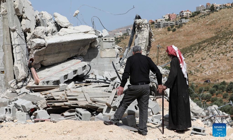 People inspect a house demolished by an Israeli army force in the West Bank village of Beit Dajan, east of Nablus, May 9, 2022.(Photo: Xinhua)