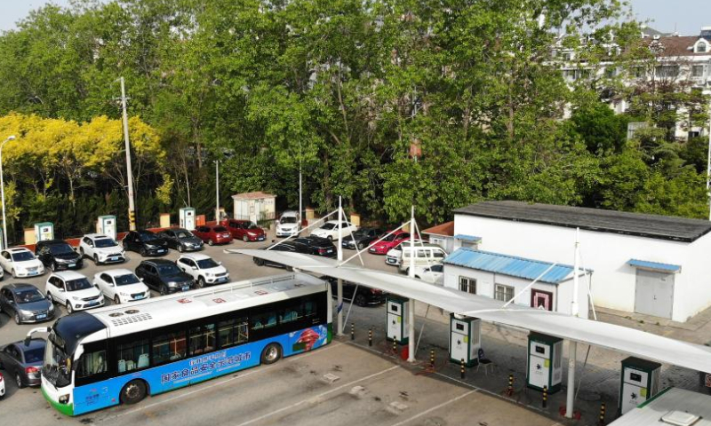 Aerial photo taken on May 12, 2022 shows a shared charging station at a bus parking lot in Qingdao, east China's Shandong Province.

Qingdao City has recently opened some electric bus charging stations to the public. Private vehicles and ride-hailing cars can share the charging facilities together with the public buses. (Xinhua/Li Ziheng)