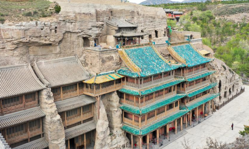 Aerial photo taken on May 11, 2022 shows the outer architecture of the Yungang Grottoes in Datong, north China's Shanxi Province.

With 45 major caves and more than 51,000 statues, the 1,500-year-old Yungang Grottoes were listed as a UNESCO World Heritage Site in 2001. (Xinhua/Cao Yang)