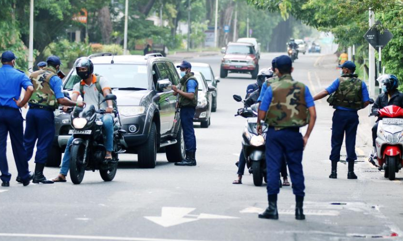Servicemen are seen on duty on a street in Colombo, Sri Lanka, on May 10, 2022. Mahinda Rajapaksa resigned as Sri Lanka's prime minister on Monday as violent protests broke out, and a nationwide curfew was imposed until Wednesday. (Photo by Ajith Perera/Xinhua)