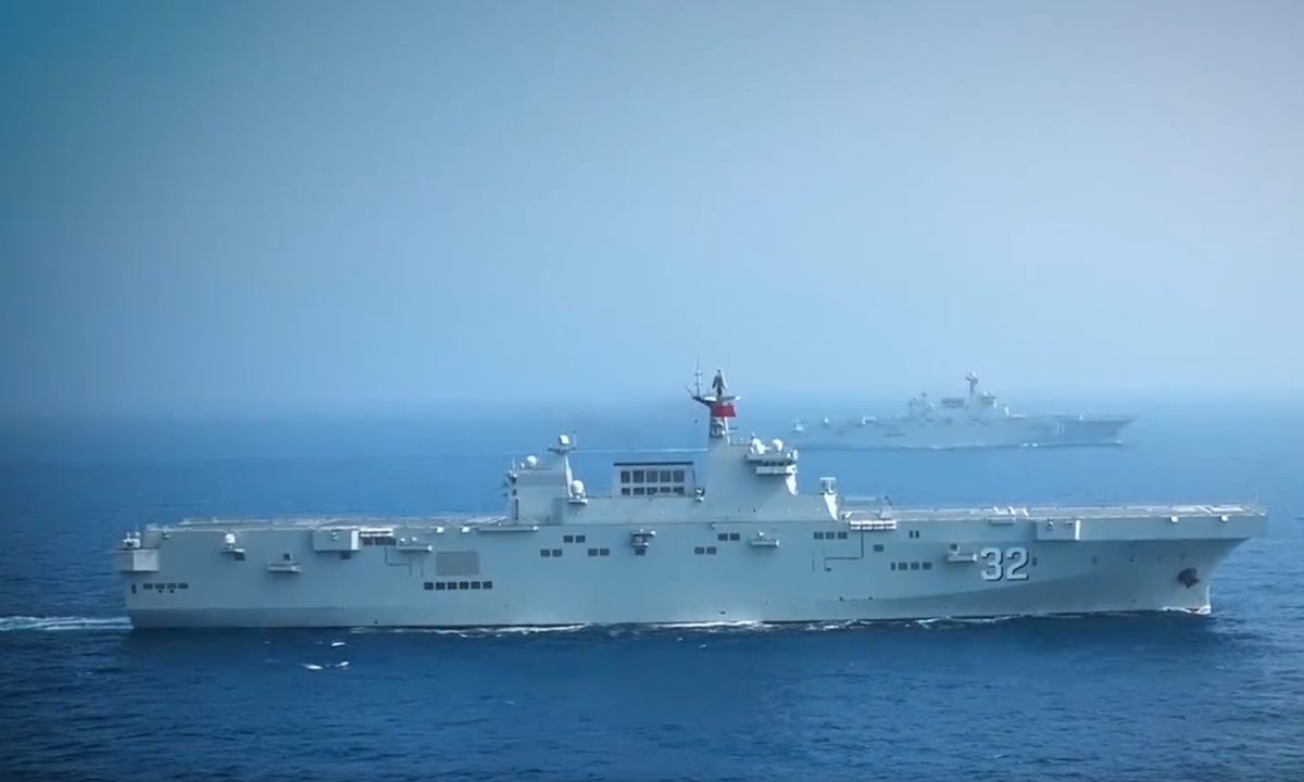 Two Type 075 amphibious assault ships of PLA Navy, the <em>Guangxi</em> and the <em>Hainan</em>, sail in formation at an undisclosed sea region in 2022. Photo: Screenshot of a video released by the PLA Navy.