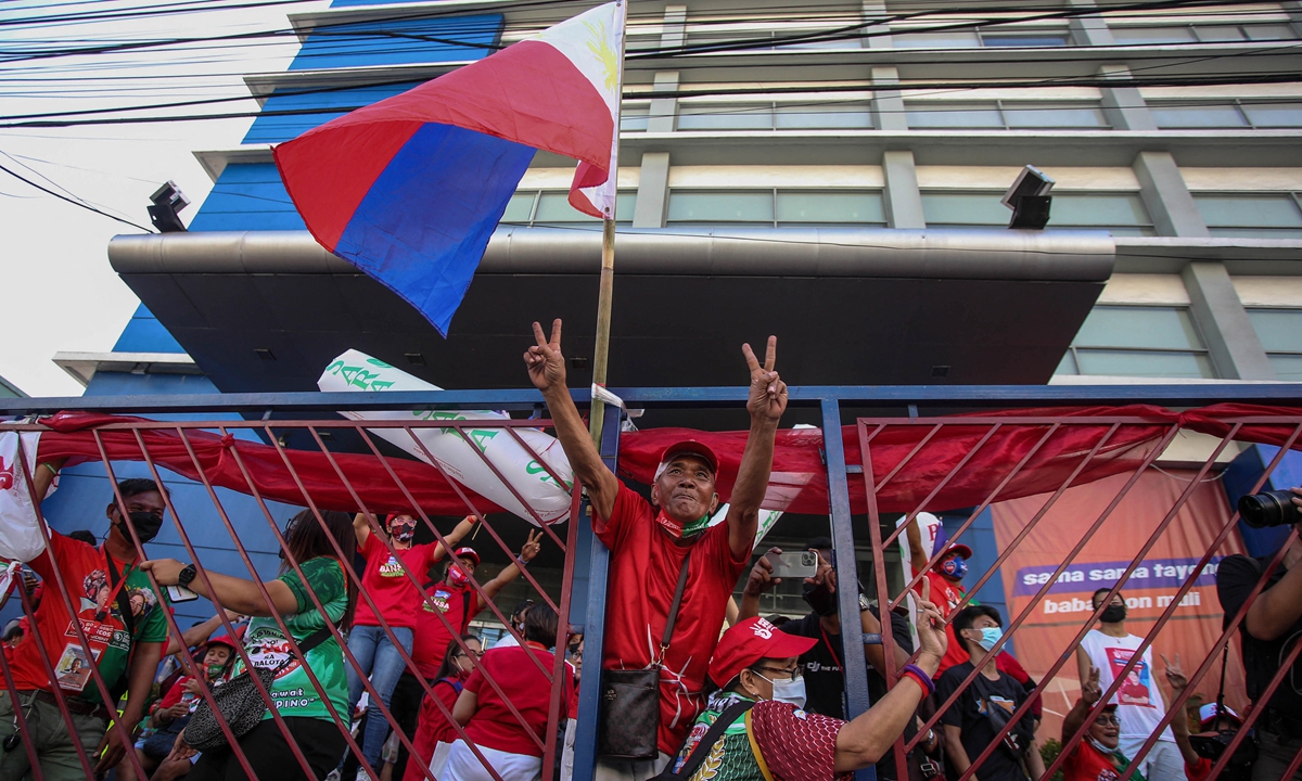 Supporters of Ferdinand Marcos, Jr. celebrate outside his campaign headquarters after his landslide presidential election victory, in Mandaluyong City, Metro Manila, on May 10, 2022. Photo: AFP