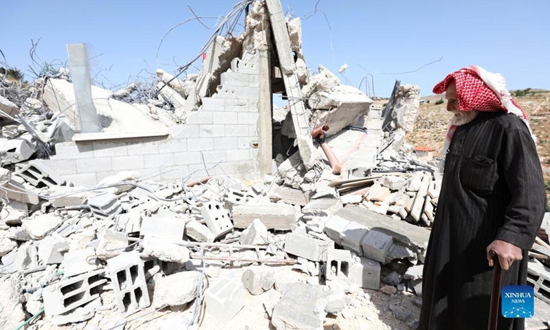 A man inspects a house demolished by an Israeli army force in the West Bank village of Beit Dajan, east of Nablus, May 9, 2022.(Photo: Xinhua)