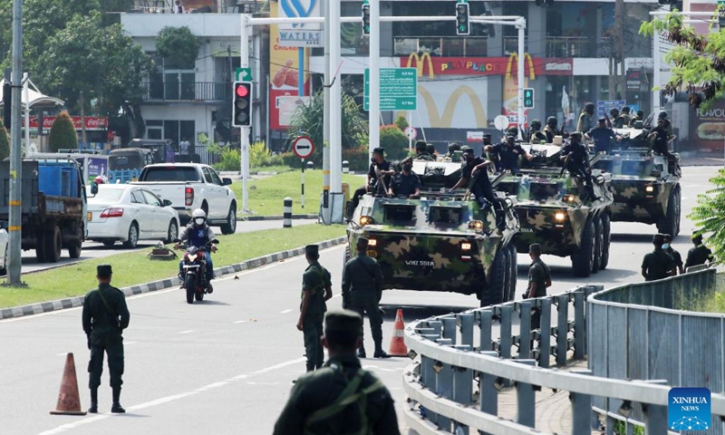 Servicemen on military vehicles patrol on a road in Colombo, Sri Lanka, on May 11, 2022. Violent protests in Sri Lanka led to the resignation of Prime Minister Mahinda Rajapaksa on Monday. A nationwide curfew was then imposed.(Photo: Xinhua)