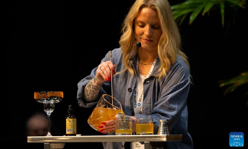 A bartender competes during the Beyond The Rail Cocktail Competition at the 2022 Restaurants Canada Show in Toronto, Canada, on May 10, 2022. Six teams of Canada's top bartenders took part in this battle of bars to shake, sling and stir their finest cocktail creations here on Tuesday.(Photo: Xinhua)