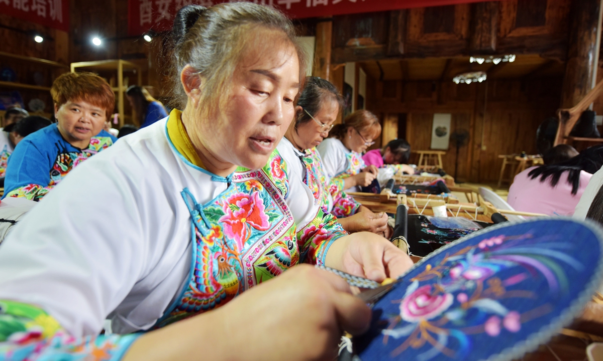 Miao people work on embroidery in Chongqing. Photos: VCG