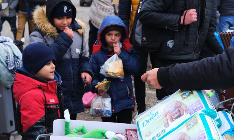 Children from Ukraine wait to receive aid supplies at the border in Medyka, Poland, on Feb. 28, 2022.(Photo: Xinhua)
