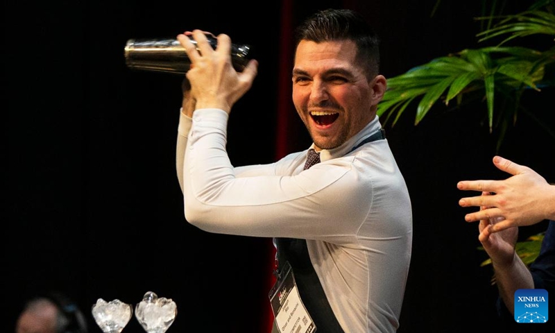 A bartender shakes a cocktail shaker during the Beyond The Rail Cocktail Competition at the 2022 Restaurants Canada Show in Toronto, Canada, on May 10, 2022. Six teams of Canada's top bartenders took part in this battle of bars to shake, sling and stir their finest cocktail creations here on Tuesday.(Photo: Xinhua)