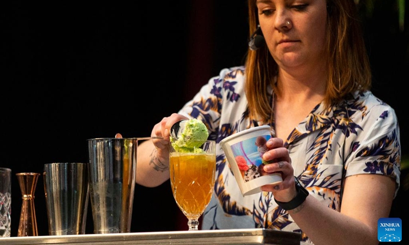 A competitor puts ice cream into a glass during the Beyond The Rail Cocktail Competition at the 2022 Restaurants Canada Show in Toronto, Canada, on May 10, 2022. Six teams of Canada's top bartenders took part in this battle of bars to shake, sling and stir their finest cocktail creations here on Tuesday.(Photo: Xinhua)