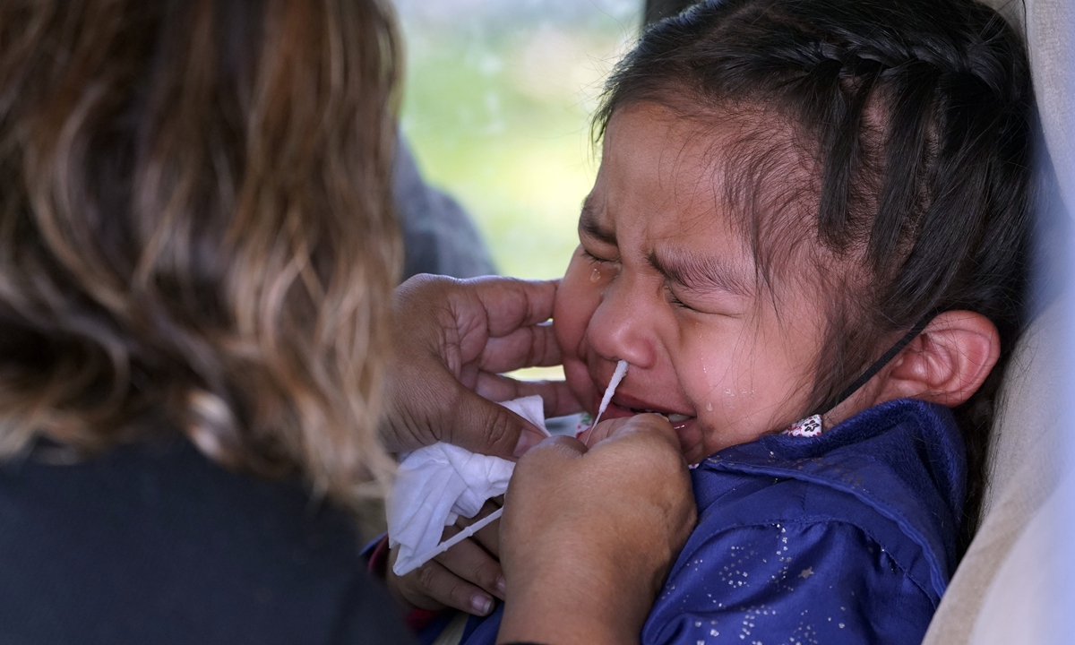 A 4-year-old girl grimaces as she's tested for COVID-19 in Whittier, California on January 25, 2022. Photo: VCG