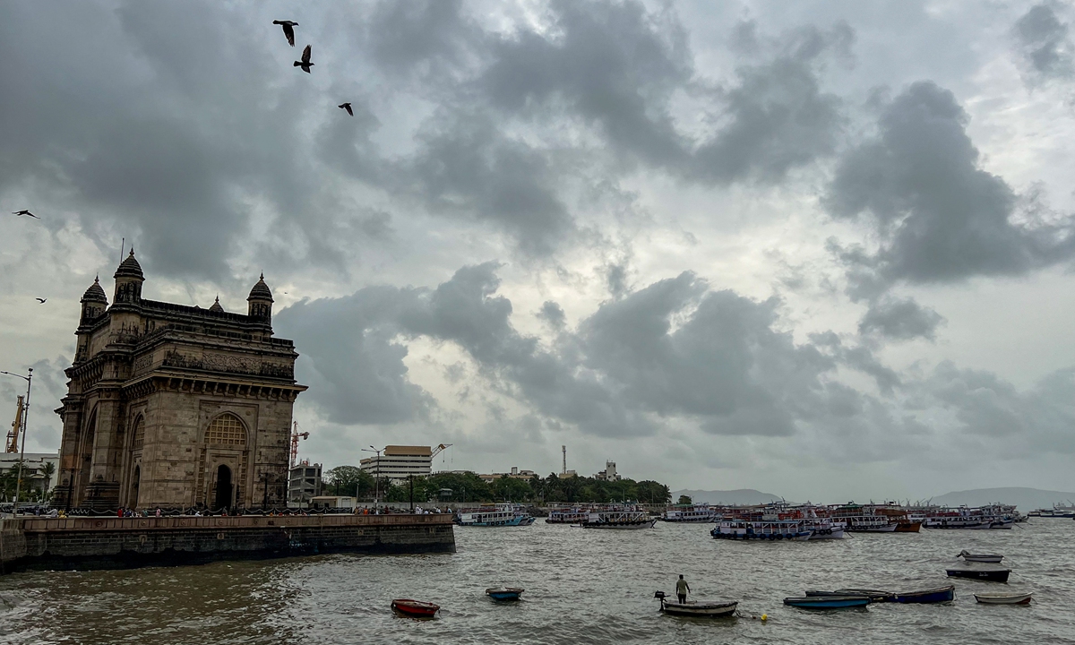 Clouds gather over the Gateway of India in Mumbai, India on May 12, 2022. After a second heat wave, light rains may bring a relief in Mumbai, the Hindustan Times said. Photo: AFP