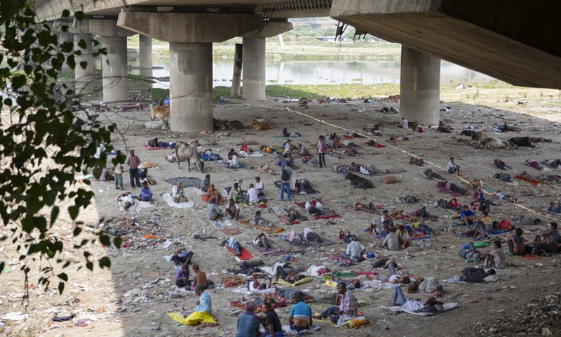 People take rest under a bridge to get respite from the hot summer day in New Delhi, May 12, 2022.(Photo: Xinhua)