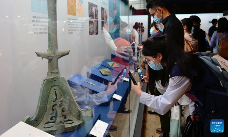 Visitors take photos of exhibits at an exhibition named Share the Same River: Bronze Age Civilization in the Yangtze River Valley at Fujian Museum in Fuzhou City, southeast China's Fujian Province, May 12, 2022.(Photo: Xinhua)