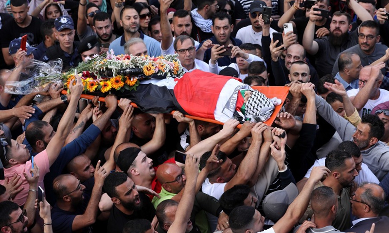 People carry the body of killed journalist Shireen Abu Akleh during her funeral in the West Bank city of Ramallah, on May 11, 2022. (Photo: Xinhua)