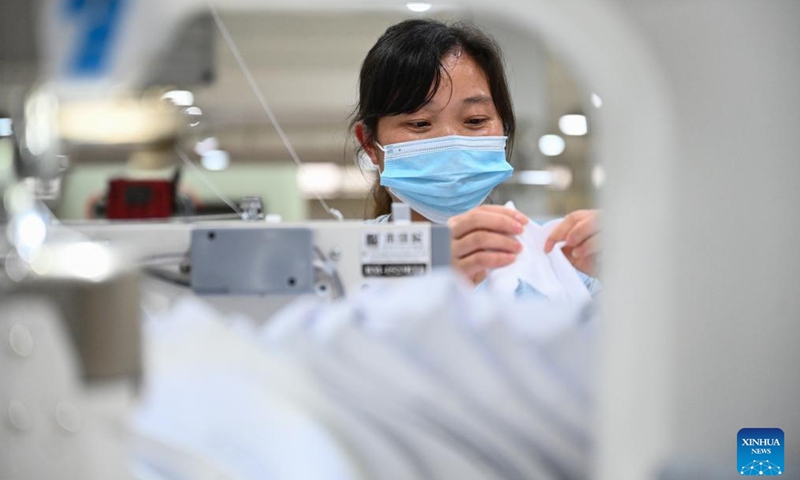 A staff member works on a production line in a sports shoe company in Jinjiang City, southeast China's Fujian Province, May 14, 2022.Photo:Xinhua