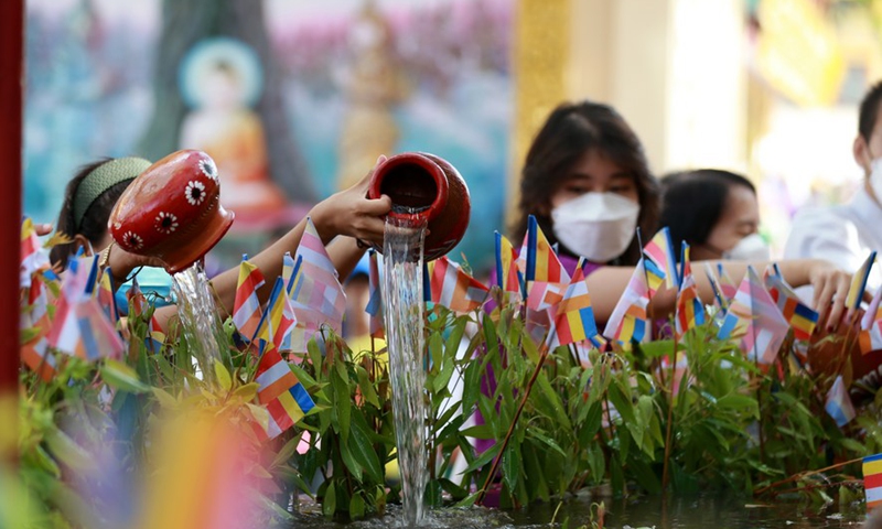 People water a Bodhi Tree at the Shwedagon Pagoda in Yangon, Myanmar, May 14, 2022.Photo:Xinhua