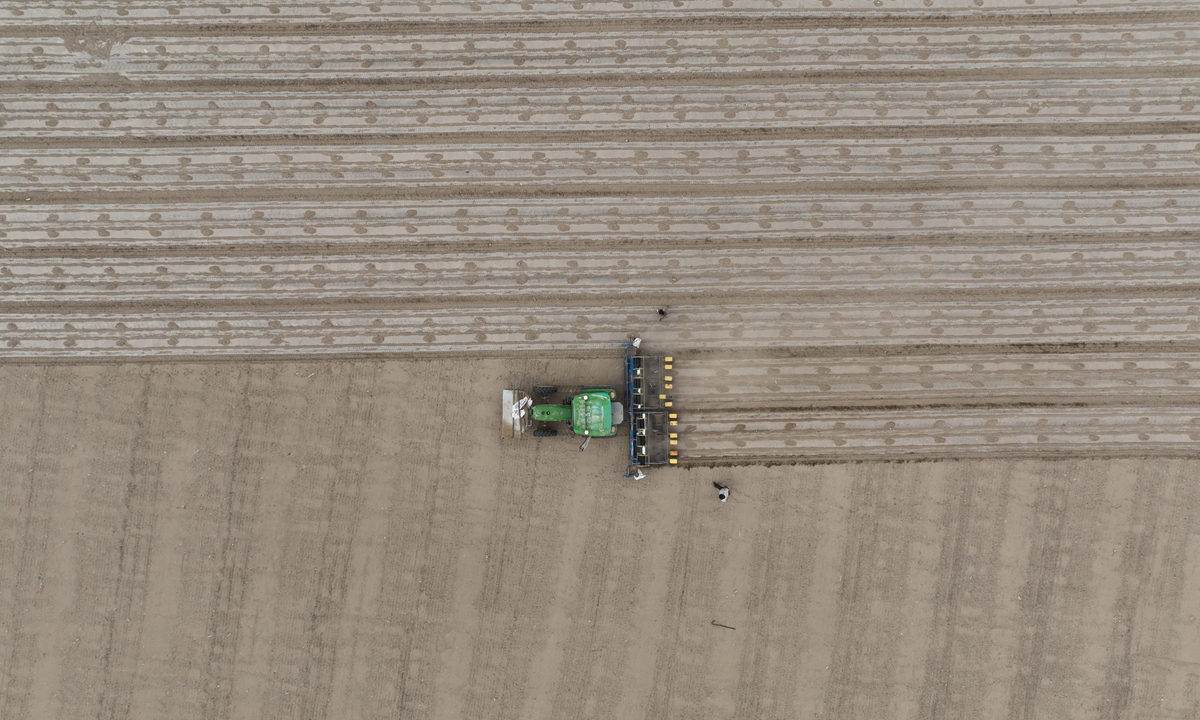 Farmers sow cotton seeds with a seeder equipped with the BeiDou Navigation Satellite System in Bohu county, Northwest China's Xinjiang Uygur Autonomous Region on April 8, 2022. Photo: VCG