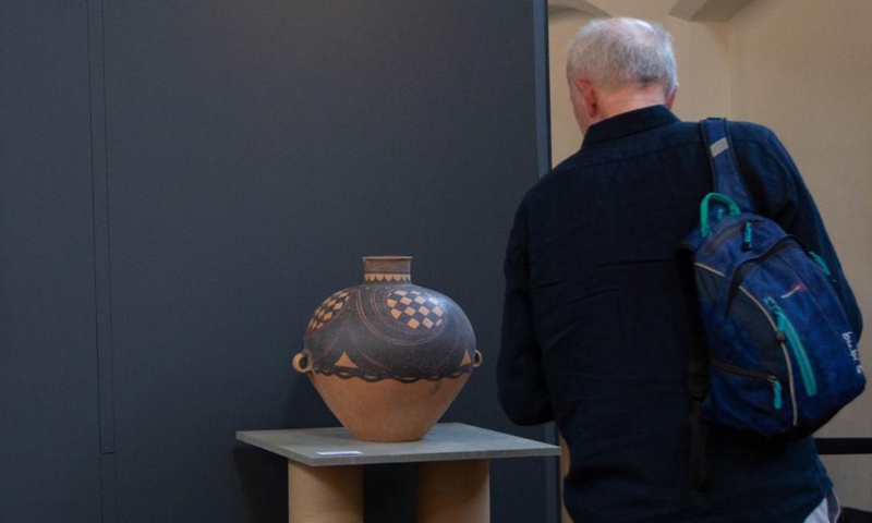 A man views an exhibit at an exhibition of pottery artworks entitled Echoes of Majiayao in Delft, the Netherlands, on May 14, 2022.Photo:Xinhua