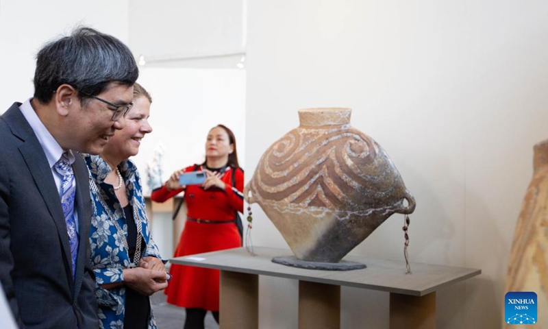 Delft Mayor Marja van Bijsterveldt (2nd L) and Chinese Ambassador to the Netherlands Tan Jian (1st L) view an exhibit at an exhibition of pottery artworks entitled Echoes of Majiayao in Delft, the Netherlands, on May 14, 2022.Photo:Xinhua