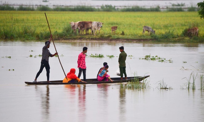 Villagers row a boat to a safer place in Bakula Guri village, Nagaon district of India's northeastern state of Assam, May 15, 2022.Photo:Xinhua