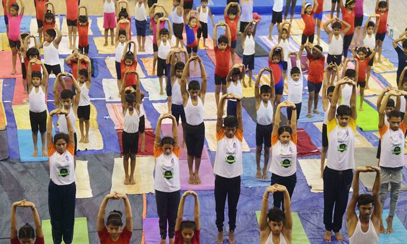 The National Service Scheme (NSS) volunteers perform yoga in the indoor hall of the state sports complex at Agartala, the capital city of India's northeastern state of Tripura, May 14, 2022.Photo:Xinhua