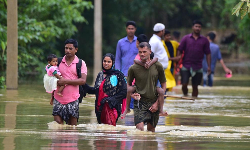 Villagers wade through a flooded area of Bakula Guri village in Nagaon district of India's northeastern state of Assam, May 15, 2022.Photo:Xinhua