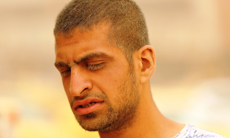 A man is seen during dust storm in Baghdad, Iraq, on May 16, 2022. A dust storm swept across much of Iraq on Monday, sending more than 2,000 people to hospitals with respiratory problems and forcing the closure of airports, schools and some government offices.(Photo: Xinhua)