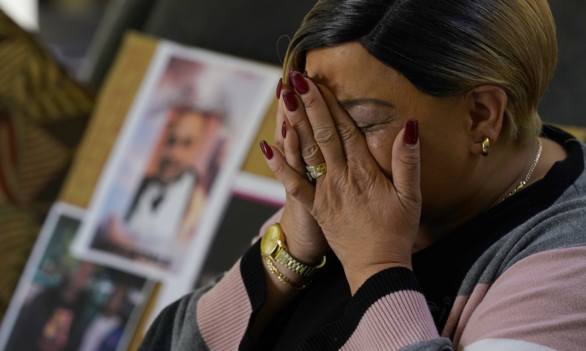 A family member of one of the victims of a mass shooting in Sacramento, California, cries during an interview on April 4, 2022.  