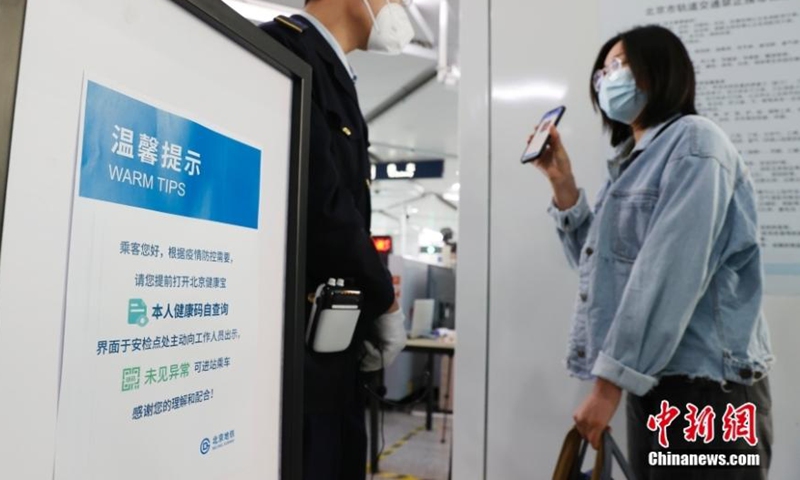 A woman shows her green health code before entering a subway station in Beijing, May 17, 2022. (Photo: China News Service/Han Haidan)