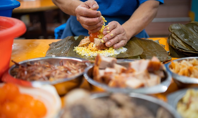 Photo taken on May 12, Macao, south China, shows how zongzi, a festive food, is made.(Photo: Xinhua)