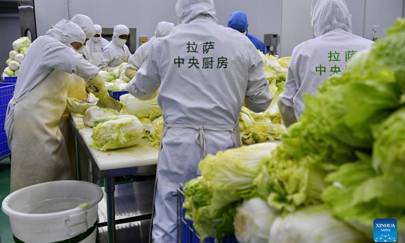 Staff members prepare food material at a catering company in Lhasa, southwest China's Tibet Autonomous Region, May 12, 2022. With the operation of a catering company, some 12,000 students of six primary schools in Chengguan District of Lhasa now enjoy nutritious lunches.(Photo: Xinhua)