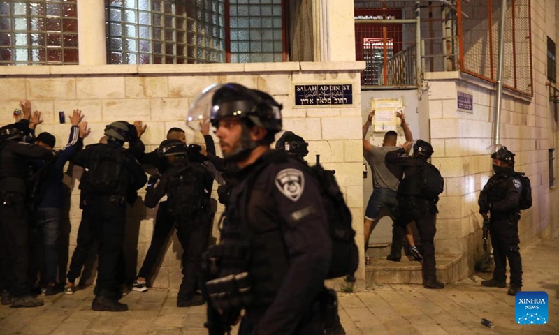 Israeli police detain Palestinians during clashes between the two sides in Jerusalem on May 16, 2022. Clashes erupted between Palestinians and Israeli police in East Jerusalem on Monday night as thousands gathered for the funeral of a young Palestinian who died after being injured in clashes with police in April.(Photo: Xinhua)