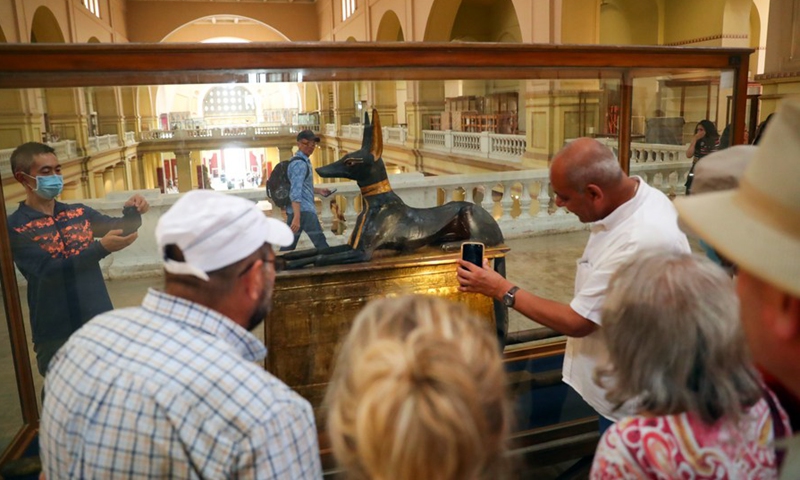 Tourists view the statue of god Anubis discovered at the tomb of king Tutankhamun, at the Egyptian Museum in Cairo, Egypt, on May 14, 2022.(Photo: Xinhua)
