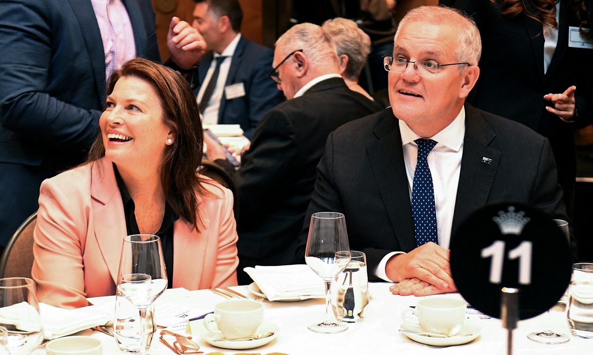 Australian Prime Minister Scott Morrison (right) and wife Jenny greet people at the Australia-Israel Chamber of Commerce luncheon as he campaigns in Melbourne on May 18, 2022, ahead of the May 21 general election. Australia's national election has become too close to call, polls out on May 18, 2022 showed, as the ruling conservative coalition narrowed the gap with the main opposition Labor Party, said CNBC. Photo: AFP