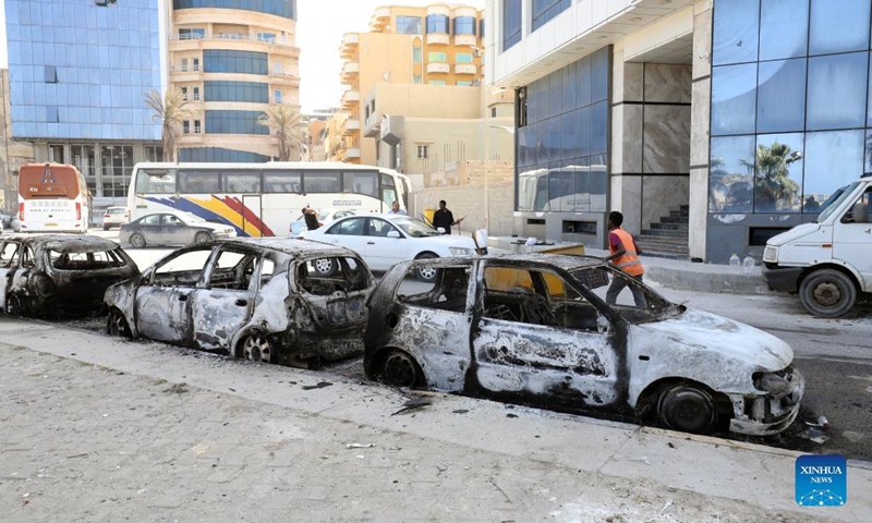 Damaged cars are seen after clashes in the capital Tripoli, Libya, May 17, 2022. Clashes erupted in different parts of Libya's capital Tripoli on Tuesday after the parliament-approved government, headed by Fathi Bashagha, entered the city, forcing the new prime minister to leave the capital just hours after arrival.(Photo: Xinhua)