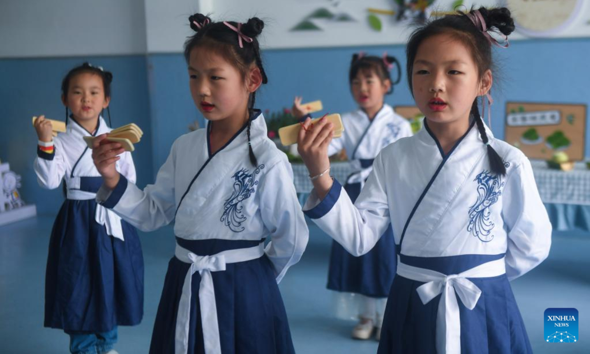 Kids of a kindergarten perform a show displaying tea culture in Lishan Town in Fuyang District of Hangzhou, east China's Zhejiang Province, May 20, 2022. Lishan Town held a series of activities to promote the traditional Chinese tea culture and greet the International Tea Day, which falls on May 21 annually. Photo:Xinhua