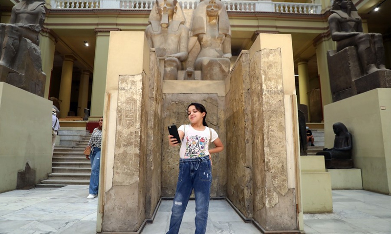 A girl takes a selfie with exhibits during the International Museum Day at the Egyptian Museum in Cairo, Egypt, on May 18, 2022.(Photo: Xinhua)
