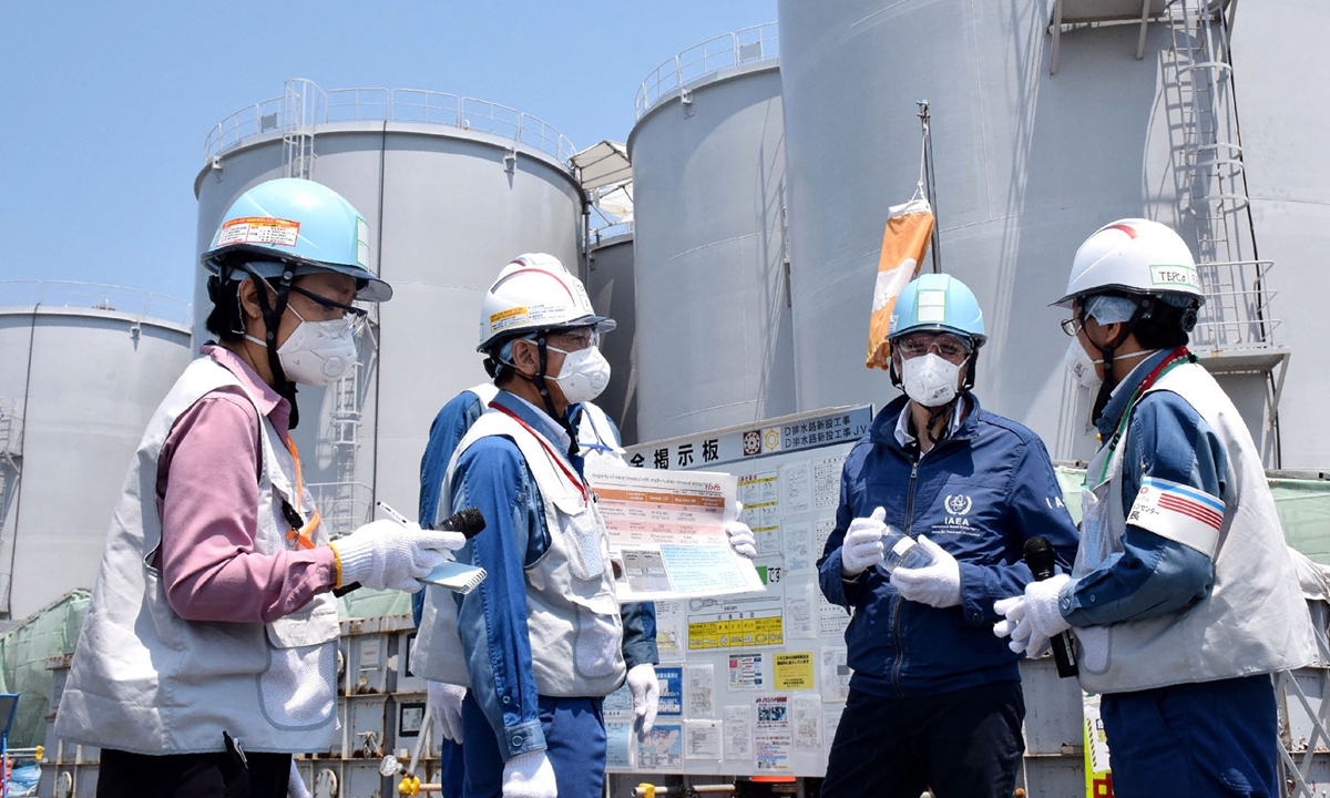 International Atomic Energy Agency Director General Rafael Grossi (second from right) stands in front of the storage tanks for radioactive water as he visits the Tokyo Electric Power Company Holdings Fukushima Daiichi nuclear power plant in Okuma, Japan, on May 19, 2022. Photo: VCG