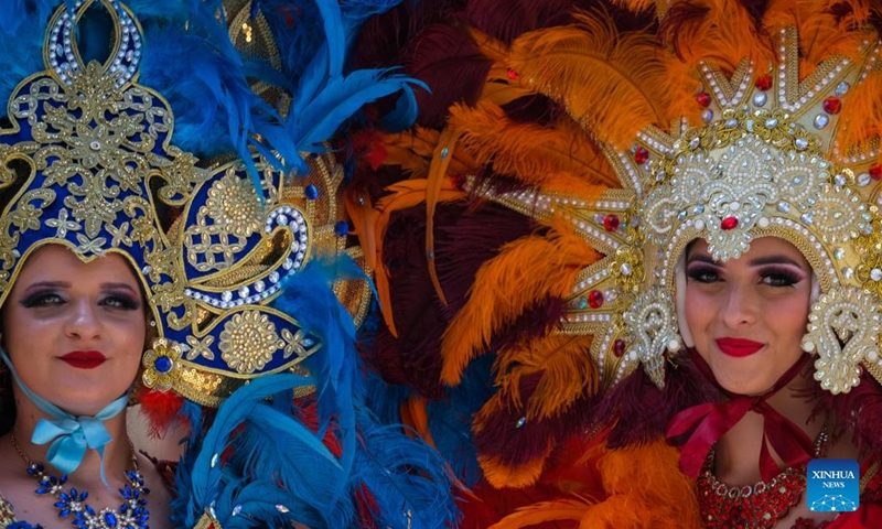 Photo taken shows two women wearing costumes at the Malta carnival in Valletta, Malta, on May 22, 2022.Photo:Xinhua