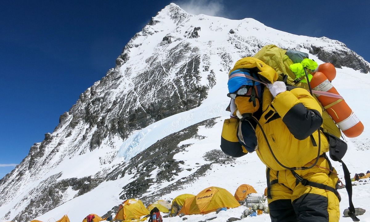 A climber rests at a camp site on Mount Qomolangma. Photos: IC