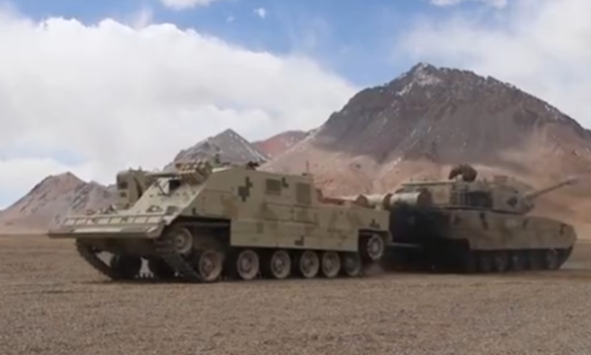 A new type of armored recovery vehicle designed based on the chassis of the Type 15 light tank attached to the Chinese People's Liberation Army Xinjiang Military Command tows a Type 15 tank in its first realistic combat drills held in the high-altitude Karakoram Mountains in Spring 2022. Photo: Screenshot from China Central Television