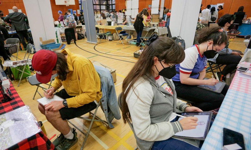 Comic artists create their comic artworks during the Vancouver Comic Art Festival in Vancouver, British Columbia, Canada, on May 22, 2022.Photo:Xinhua