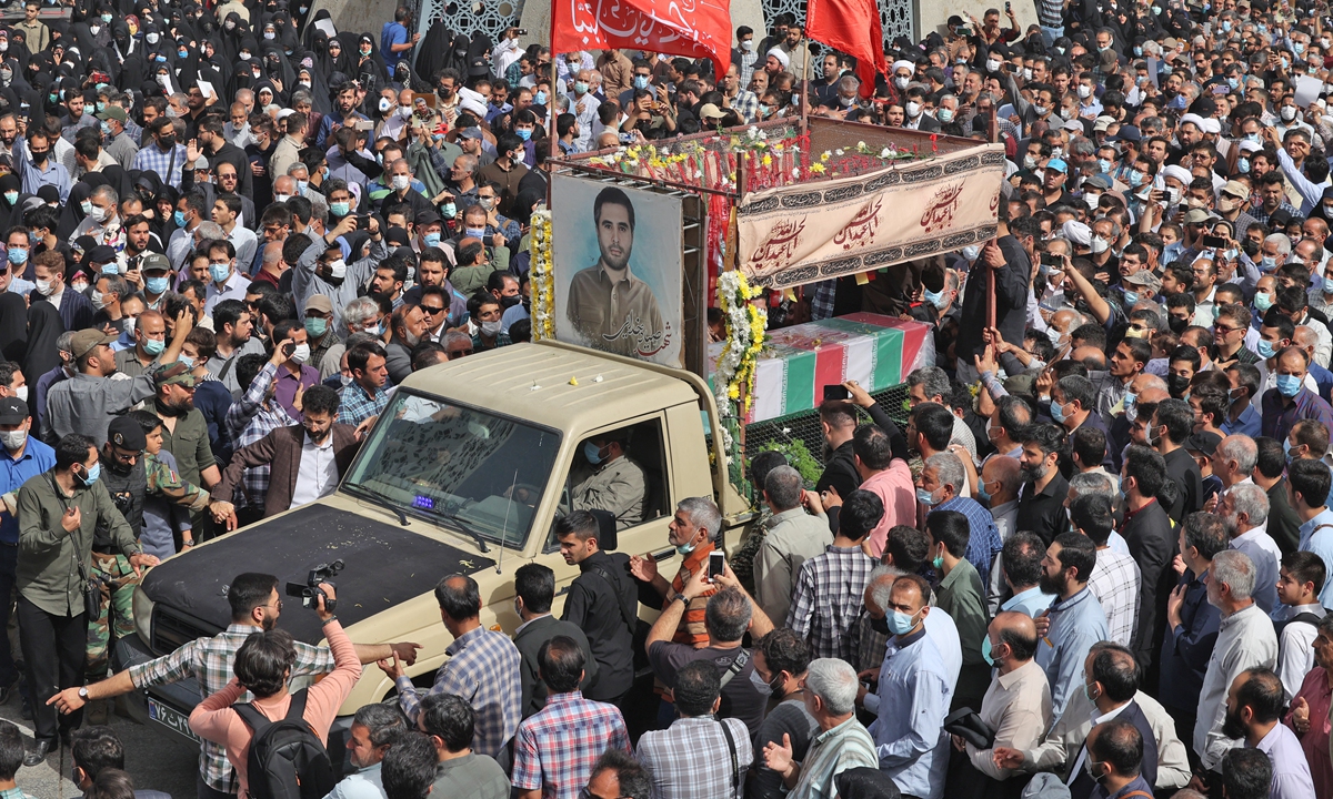 Mourners gather around the coffin of Revolutionary Guard Colonel Hassan Sayyad Khodai during a funeral procession at Imam Hussein square in the capital Tehran, Iran on May 24, 2022. Assailants on motorcycles on May 22, 2022 hit Khodai with five bullets as he sat in his car outside his home. Photo: AFP