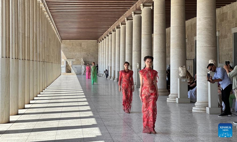 Models present creations of Greek fashion designer Vassilios Kostetsos at the Stoa of Attalos in ancient Agora of Athens, Greece, on May 23, 2022.Photo:Xinhua