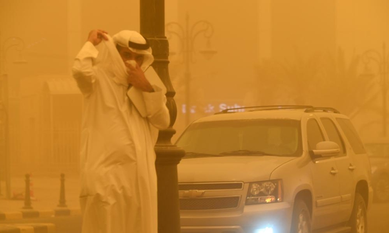 A man walks at a street amid strong dust storm in Kuwait City, Kuwait, on May 23, 2022.Photo:Xinhua